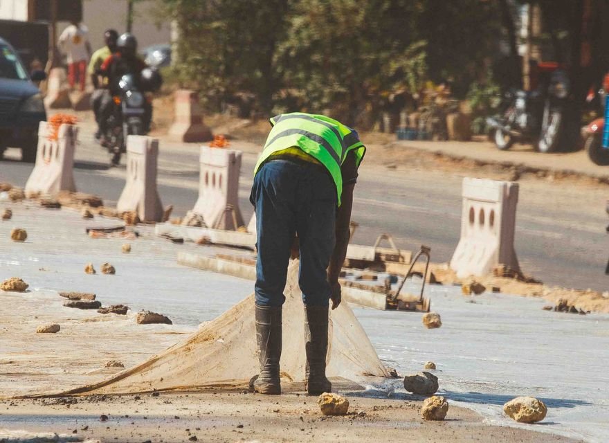 Construction workers laying an asphalt road surface