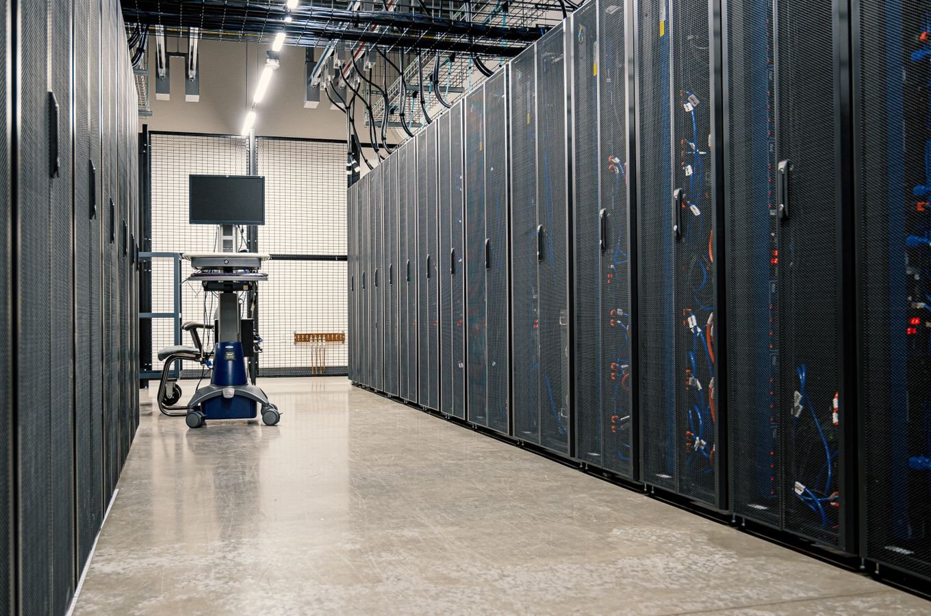 Data center corridor with server racks and network equipment